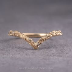 a gold ring with intricate designs on it