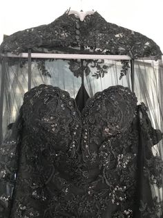 the back of a black wedding dress on display