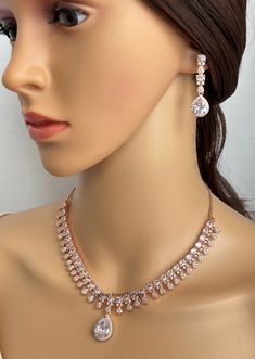 White Rosegold CZ diamond Necklace,Indian Pakistani wedding Jewelry,Mother of the Bride,Crystal Necklace, Bridesmaid, Gift for her Gorgeous Pink CZ Set in aaa quality CZ stones rose gold finish  This American Diamond Necklace Set comes with a pair of earrings and tikka  Regular size and adjustable Arrives in a gift box. Highest quality and craftsmanship Ready to ship from California, United States and delivery in 3-5 days in US Please let me know if you have any questions. Thank you so much for visiting my shop. Color, shades, and texture displayed may slightly vary from the actual product due to digital image limitations. We request you to consider these minor variations. Please expect the possibility of some slight imperfections when buying handmade jewelry. If you have any questions, pl Formal Rose Gold Crystal Jewelry Sets, Rose Gold Wedding Jewelry Sets With Diamond Accents, Dazzling Rose Gold Bridal Necklace For Formal Occasions, Rose Gold Wedding Necklaces With Diamond Accents, Rose Gold Cubic Zirconia Bridal Necklace For Anniversary, Rose Gold Wedding Necklace With Diamond Accents, Rose Gold Diamond Accent Wedding Necklace, Wedding Rose Gold Necklace With Diamond Accents, Crystal Bridal Necklace With Prong Setting For Wedding