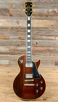 an electric guitar sitting on top of a wooden table