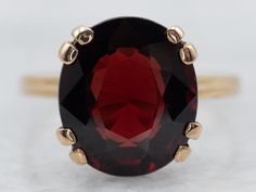 This beautiful yellow gold solitaire ring showcases a single garnet gemstone. Its timeless design and quality craftsmanship lasts for generations, providing you with a timeless piece of jewelry for decades to come.Metal: 18K Yellow GoldGem: Garnet 5.11 CaratsGem Measurements: 9.9 x 11.3 mm, OvalRing Size: 6.50 Formal Garnet Ring With Center Stone, Formal Garnet Birthstone Ring In Fine Jewelry Style, Formal Garnet Birthstone Ring Fine Jewelry, Formal Garnet Birthstone Ring, Classic Yellow Gold Garnet Rings, Classic Yellow Gold Garnet Birthstone Ring, Classic Garnet Birthstone Ring In Yellow Gold, Formal Solitaire Ruby Ring In Yellow Gold, Formal Yellow Gold Ruby Solitaire Ring