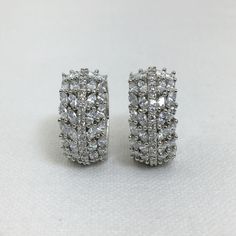 Elevate your style with our stunning Diamond Huggies from SapphireArtTreasure. These American Diamond-encrusted earrings feature wide hoops that add a touch of modernity and elegance to any ensemble. With their timeless design and sparkling allure, these Diamond Huggies are perfect for both casual and formal occasions. Make a statement and exude confidence with these exquisite earrings that will surely turn heads wherever you go. *𝐏𝐑𝐎𝐃𝐔𝐂𝐓 𝐃𝐄𝐓𝐀𝐈𝐋* * Material: Brass * Plating: White R White Diamond Sparkling Hoop Earrings, Sparkling White Diamond Hoop Earrings, Hoop Earrings With Sparkling Stones For Gift, Diamond White Hoop Earrings With Sparkling Stones For Wedding, White Cubic Zirconia Hoop Diamond Earrings, Wedding Hoop Earrings With Diamond Accents And Cubic Zirconia, Dazzling White Sparkling Hoop Earrings, Silver Hoop Earrings With Sparkling Stones For Wedding, White Gold Hoop Earrings With Sparkling Stones For Gift