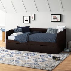 a bed sitting on top of a wooden floor next to a dresser under a window