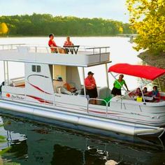 people are riding on the back of a house boat