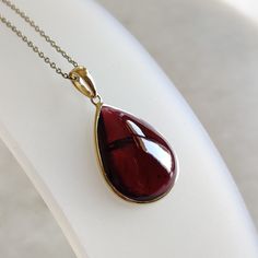 ITEM DESCRIPTION: >> The Pendant is made from Solid 14K Yellow Gold. Gemstone used is absolutely natural and ethically sourced. >> Natural Garnet in cabochon cut and pear shape with bezel setting is studded on it with utmost precision.  >> This is a minimalist design and is absolutely hassle-free and everyday jewelry.  Gem: Garnet Gem size: 15x20 mm pear Gem weight: 15.54 carats Gold purity: 14K (58.33% approx.) Gold weight: 0.57 grams  Gross weight: 3.68 grams The Gold purity is guaranteed and it comes with authentic 14K gold hallmark. Since this Pendant are handmade, It is Nickel/Lead FREE.  CUSTOMIZATION: --> You can choose your own gemstone. --> Kindly drop a message for the same. CUSTOMER SUPPORT: --> We are available 24/7 to respond to all your queries!  PACKAGING: --> The pendant co Cabochon Drop Jewelry For Gifts, Classic Polished Gemstones As A Gift, Classic Polished Gemstones For Gift, Classic Polished Gemstones For Gifts, Hallmarked Yellow Gold Gemstones For Gift, Classic Handmade Gemstones As Gifts, Classic Handmade Gemstones For Gifts, Pear-shaped Ruby Jewelry Gift, Handmade Classic Gemstones For Gifts