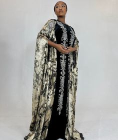 Our impeccable luxury Dubai cape Abayas are exclusive to the uk.  This embellished embroidered  masterpiece has beautiful silver gems all over. Features: * bust & waist clip button fastening  * Two toned fabric * loose fit - cape style * Made in Dubai * fabric is not see through or stretchy SIZE: Fits sizes uk 0-22 Abaya size 58 ( fits heights 5ft 7-5ft8) Perfect for all special occasions to wear on top of a plain max dress, jumpsuit or jilbab & jilbab. To see more of our products be sure to che Luxury Floor-length Festive Abaya, Festival Embellished Floor-length Abaya, Luxury Floor-length Modest Abaya, Luxury Embroidered Floor-length Abaya, Embellished Black Floor-length Abaya, Max Dress, Dress Jumpsuit, Cape Style, Hijab Dress