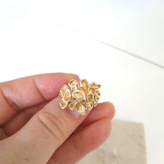 This is an absolutely amazing fancy statement gold ring. The ring is custom made and has a romantic touch into it. It is made of 10k solid yellow gold and weighs 5.5 grams. The size is 4.5 US. The ring features a gorgeous looking tropical flower where each petal is artistically crafted and different. The ends of each petal have a diamond cut, which makes the ring shine. The top of the ring measures 0.8 inches. The ring has a '10k' gold hallmark. The ring will definitely make a beautiful gift for any special occasion. The ring comes in a jewelry box and with a 'Thank you' card. If you are not satisfied with a ring, I will gladly accept a return. Contact me within 3 days of delivery and dispatch the item back within the next 3 work days. For more jewelry in my store visit: https://www.etsy.c Yellow Gold Brass Rings For Anniversary, Fine Jewelry Brass Rings For Anniversary, Gold Recycled Gold Rings For Gifts, Gold Rings Made Of Recycled Gold As A Gift, Gold Recycled Gold Ring Gift, Unique Recycled Gold Rings For Gift, Gift Gold Ring Made Of Recycled Gold, Elegant Handmade Gold Flower Ring, Handmade Gold Flower Ring For Wedding