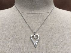 "This is such a unique and whimsical heart pendant necklace. It has incredible detail and another little heart showcased inside the main heart. This would make a very sweet and meaningful gifts for a loved one on any occasion. The heart measures 1\" long by 5/8\" wide and is made from allergy free plated silver. It hangs from a simple 18\" stainless steel necklace chain. I have matching earrings in my shop, if you would like the whole set. Here is the link https://etsy.me/30EwF2x Thanks for stop Nickel-free Double Heart Necklace For Anniversary Gift, Metal Heart Necklace With Open Heart And Heart Beads, Metal Heart Necklace With Heart Beads, Metal Heart Necklace With Open Heart Shape, Metal Open Heart Necklace With Heart Beads, Spiritual Silver Heart Charm Necklace, Valentine's Day Engraved Open Heart Charm Necklace, Heart-shaped Charm Necklaces For Anniversary, Heart Shaped Charm Necklaces For Anniversary