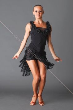 a woman in a black dress is posing for the camera with her legs spread out