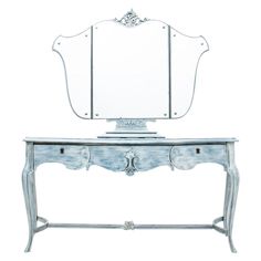 an antique vanity with mirror on top and drawers in the bottom half, against a white background