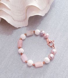 "Pink Pearl, morganite, White shell beaded bracelet made with natural pearl, gemstone and 18 kt rose gold filled clasp. Bracelet Length: 7 \" Morganite  Barrel  : 15x8  mm  pink round  pearl:  10 mm white shell carved bead : 10 mm  Italian made rose gold filled Clasp: 25x10mm The bracelet is hand knotted with silk thread . It is nice and comfortable for everyday wear and it comes with the beautiful package which are ready for gift giving. Please feel free to message me if you want to see more photos . SHOP BRACELET: https://www.etsy.com/il-en/shop/kennariesjewellery/search?search_query=bracelet&order=date_desc&view_type=gallery&ref=shop_search CLICK HERE TO RETURN TO MY SHOP: http://www.kennariesjewellery.etsy.com Please feel free to message me if you want to see more photos. Worldwide fre Elegant White Rose Quartz Crystal Bracelet, Rose Gold Beaded Bracelets With Gemstone Beads, Handmade Elegant Rose Quartz Crystal Bracelet, Elegant Hand-strung Rose Quartz Crystal Bracelet, Handmade Rose Gold Rose Quartz Beaded Bracelet, Elegant Beaded Rose Quartz Crystal Bracelet, Elegant Rose Gold Beaded Bracelets With Rose Quartz, Elegant Rose Gold Bracelets With Natural Stones, Elegant Rose Gold Beaded Rose Quartz Bracelets