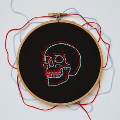 a black and red embroidery with a skull on it