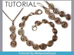 a necklace and earring set made from metal wire with spirals on the end