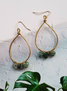 Handmade hammered brass tear drop dangle earrings, with green gemstone chips wrapped around the bottom These handshaped earrings are very lightweight and so versatile, they will go with any outfit  The teardrops are hung from gold plated french hooks The chips have been repurposed from preloved jewellery  They measure approximately 4cm Green Teardrop Brass Jewelry, Bohemian Green Teardrop Earrings, Green Bohemian Teardrop Earrings, Bohemian Green Teardrop Drop Earrings, Green Bohemian Teardrop Drop Earrings, Bohemian Gemstone Teardrop Earrings, Gold Hand Wrapped Teardrop Earrings, Green Bohemian 14k Gold Filled Earrings, Bohemian Teardrop Jade Earrings