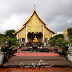 a large golden building sitting on top of a lush green field