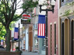 an american flag hanging from the side of a building