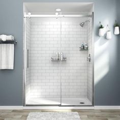 a bathroom with blue walls and white tile on the floor, including a walk in shower