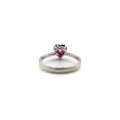 This is part of Chairish’s Fine Jewelry assortment.  This 18k white gold ring features a beautifully coloured heart-shaped garnet. The garnet is a saturated deep magenta, with facets that sparkle in many different hues of pink and red. It is prong set with three prongs; the back of the carriage or underside of the ring is a heart shape as well, for an adorable added touch. A wonderful sweetheart ring , this is the perfect gift to show someone your love or your self love.  The rings weighs 2.9 gr Fine Jewelry Gemstone Heart Cut Rings, Formal Heart Cut Ruby Ring In Fine Jewelry Style, Elegant Heart Shaped Sapphire Ring For Formal Occasions, Heart Cut Fine Jewelry Ring For Valentine's Day, 14k White Gold Heart Cut Rings, Formal Heart Ring For Valentine's Day With Round Cut, Heart Shaped Solitaire Birthstone Ring In Fine Jewelry Style, Fine Jewelry Heart Ring With Round Cut Gemstone, Fine Jewelry Heart Ring With Prong Setting