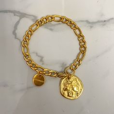 «Athena basic " " bracelet  ⚜️this is a beautiful everyday- easy to wear -  bracelet made of clsssic gourmet steel chain .  This chain is polished and has a smooth fine finish . it has an antique quite dark 24k  gold color tone .  It is decorated with a coin  charm made of gold plated 24k zamac  Available in various lengths as linked to options.  Pls check equivalence of cm to inches to find your size !  17 cm equals - 6.7 inches ( very small size )  18cm - 7 inches  19 cm - 7.5 inches ( regular Classic Gold-tone Bracelet With Chunky Chain, Chic Gold-plated Chunky Chain Bracelet, Gold-plated Chunky Link Bracelet, Yellow Gold Chunky Chain Bracelet, Gold Plated, Luxury Gold-tone Bracelet With Chunky Chain, Coin Charm Bracelet, Basic Bracelet, Coin Bracelet, Steel Chain