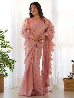 Introducing our stunning "fascinating peach organza designer readymade saree with blouse" that is sure to make you stand out at any party or reception. Made from high-quality peach color organza material, this saree features intricate ruffle details and a fancy lace border for a touch of elegance. The saree comes with a fully stitched blouse material in matching color and is available in sizes XS to XXL, making it the perfect fit for everyone.
This saree include its trendy lace work, which adds Lehenga Crop Top, Lehenga Choli Wedding, Floral Lehenga, Party Wear Lehenga Choli, Bollywood Lehenga, Ruffle Saree, Readymade Saree, Ready To Wear Saree, Organza Sarees