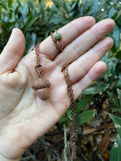 Presenting a remarkable pendant made using the copper electroforming technique on an actual acorn. The acorn pendant measures less an 1 inch in length. It is accompanied by a 20-inch copper chain adorned with an unakite bead and secured with a lobster clasp. Photographed in natural daylight, the pendant's authentic colors are showcased without any filters or enhancements, offering an element of natural sophistication to your ensemble. The acorn, in its natural state and when electroformed, posse Oak Acorn, Antique Flatware, Copper Electroforming, Acorn Pendant, Acorn Necklace, Trade Beads, Copper Chain, Found Object, Jewelry Creation