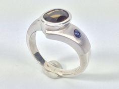 "Hi everyone, just wanted to let you know we are open and shipping daily. Beautifully crafted \"one of a kind\" contemporary Sterling Silver ring with genuine chrome tourmaline and Sapphire stones. The silver ring is finished with Rhodium so it will not tarnish. The gemstone used in this ring has been hand picked on a recent trip to Bangkok and is of a quality usually reserved for fine jewelry so you will almost never find such nice stones set in sterling silver! Weight 8 Grams This fine jewelry Modern Open Topaz Ring, Modern Silver Sapphire Ring With Accent Stones, Modern Silver Topaz Ring, Modern Sapphire Open Ring For Anniversary, Modern Open Sapphire Ring For Anniversary, Modern Sterling Silver Sapphire Ring, Silver Tourmaline Ring With Polished Finish, Modern Silver Sapphire Ring For Anniversary, Modern Topaz Promise Ring