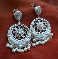 These gorgeous pair of Inaya CZ studded flower chandbali earrings can be styled with any outfit. Earrings length: Approx. 2.25” Push-Back closure. Light Weight. Matt Gold Finish / Silver - high-quality brass as base metal. Availability: In-Stock. *Color may vary slightly due to light condition & photography. Jewelry Care: Keep away from moisture. Allow perfumes and lotion to dry before wearing. Store in jewelry pouch. Clean only with soft lint free cloth. Photography Jewelry, Cocktail Earrings, Junk Jewelry, Contemporary Earrings, Chandbali Earrings, Jewelry Indian, Cz Jewelry, Cubic Zirconia Earrings, Wedding Jewelry Earrings