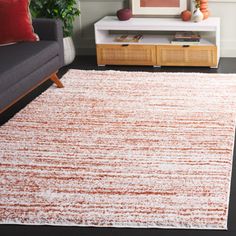 an orange and white rug in a living room