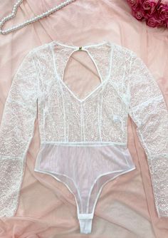 Feel absolutely fabulous in our stunning Teddy bodysuit! This exquisite piece is crafted with delicate lace, delivering a gorgeous and feminine aesthetic that celebrates your inner beauty. Designed with full-coverage long sleeves, this bodysuit allows you to confidently embrace your unique style and wear it wherever your heart desires. Long sleeve Semi-sheer Full lace Thong bottom and cotton lining V-neck Teddy Bodysuit, Teddy Lingerie, Cozy Night, Lace Long Sleeve, Feminine Aesthetic, Lace Thong, Black White Pink, Inner Beauty, Long Sleeve Lace