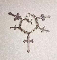 This is a for a vintage, cross charm bracelet. All the crosses are different.  It is unsigned and has not been cleaned. It has usual wear and tear for the age. The photos don't always depict the true color. I took several pictures so you could see clearly the condition they are in. If you have any questions, or problems with an order please contact me. I sell an item as is, but I will work to resolve any issues a customer may have with a purchase. My items are used so many have imperfections. This item has free shipping. Religious Cross, Cross Charms, Vintage Silver, True Colors, Jewelry Bracelets, Im Not Perfect, Charm Bracelet, Silver, Color