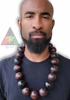 This 40mm Big Bead Wooden Necklace is hand crafted and painted by Eye Create LLC. This necklace is 30 inches in length (measured from the inside of the necklace). Make a statement without saying a word 💯 ✊🏾 PLEASE CONTACT ME FIRST BEFORE PURCHASING IF YOU HAVE A PERSONIZATION REQUEST!! Artisan Hand Painted Brown Necklace, Artisan Brown Hand Painted Necklace, Unique Hand Painted Brown Necklace, Create Llc, Bead Necklace For Men, Big Bead Necklace, Symbols Tattoos, African Inspired Jewelry, Warrior Necklace