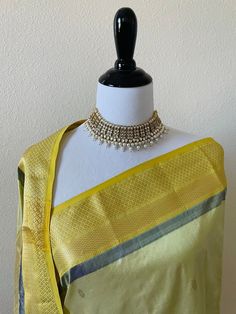 ShopNaya is proud to present our handwoven silk sarees from the weavers of Maheswar, India. Lightweight, handwoven pure silk saree in light green with gold zari border. Body of the saree has fine floral motifs in gold zari, pallu has leaf pattern in gold zari. Blouse color is yellow with the same border design as the saree. Handloom Mark tag attached. **Saree pico, falls finished, blouse is cut and sent as a separate item, unstitched. Wash care - Dry clean only PLEASE NOTE 1. As with any handloo Traditional Chanderi Blouse Piece With Tilla, Diwali Slub Silk Pre-draped Saree With Weaving Work, Festival Slub Silk Pre-draped Saree With Weaving Work, Diwali Chanderi Blouse Piece With Tilla, Festive Chanderi Blouse Piece With Tilla Details, Handloom Slub Silk Pre-draped Saree For Diwali, Festive Pre-draped Saree With Weaving Work, Handloom Raw Silk Pre-draped Saree For Festive, Navratri Silk Dupatta With Tilla Detail