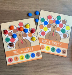 two cards with turkeys on them sitting next to candy