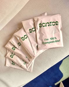 five packets of sanitos sitting on top of a bed