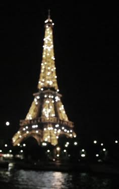 the eiffel tower is lit up at night