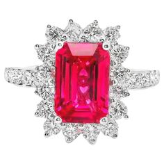 a pink tourmaline and diamond ring with white diamonds on the sides, set in 18k white gold