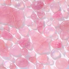 pink crystals are scattered on a white surface