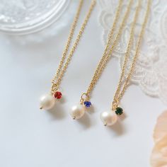 ♥ Dainty Freshwater Pearl with Blue, Green and Red stone necklace. ♥ Material - Freshwater Pearl, 18K Gold plated over 316L stainless steel chain ♥ The chain length - 12 ~ 20 inches adjustable (Please choose the length from option) ♥ Measurement - Pearl app. 8 mm, Stone - 3mm ♥ All the jewelry comes with gift wrap ♥ Please check the shop policy before you buy the products. Red Pearl Necklace Gift, Red Pearl Pendant Necklace As Gift, Red Birthstone Necklace For Weddings, Red Wedding Necklace With Birthstone, Red Pearl Chain Necklace As Gift, Dainty Red Necklace For Wedding, White Charm Necklace With Birthstone For Wedding, White Birthstone Charm Necklace For Wedding, Red Stone Necklace