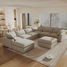 a living room with a large sectional couch in the middle and a rug on the floor