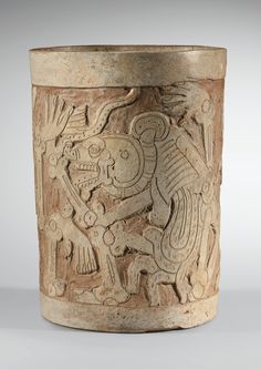 an old vase with carvings on it