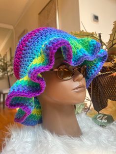 Stay stylish and on-trend with this handmade crochet ruffle hat. Made with soft and durable yarn, this hat is perfect for adding a touch of boho-chic to any outfit. The classic ruffle/bucket hat style is updated with a unique crochet design, making it a versatile and fashionable accessory for any season. Whether you're out for a day of shopping or heading to the beach, this hat is sure to keep you looking cool and feeling comfortable. Treat yourself or a loved one to this must-have accessory and add a touch of handmade charm to your wardrobe. Handcrafted with care and attention to detail, this crochet ruffle/bucket hat is a true statement piece that you'll love to wear again and again. Thank you for supporting my business and choosing handmade! CARE: Hand wash in cold water with detergent. Bohemian Adjustable Crochet Hat With Crochet Trim, Adjustable Bohemian Crochet Hat With Crochet Trim, Adjustable Crochet Hat, Bohemian Knitted Short Brim Hat, Adjustable Ruffled Hat With Curved Brim, Adjustable Multicolor Whimsical Crochet Hat, Adjustable Beanie With Ruffles, Bohemian Knitted Sun Hat With Adjustable Fit, Bohemian Adjustable Knitted Sun Hat