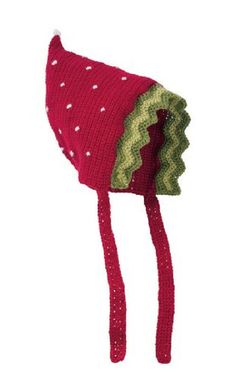 a red knitted hat with green and white dots on the top, attached to a hook