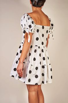 An editorial and classic style dress that makes a statement. Oversized black polka dots printed on woven cotton with a hint of stretch. Gathered detailing on sleeves and skirt. Fits a size Medium. MEASUREMENTS: Chest: 36 inches chest circumference Waist: 28 inches Body Length: 35 inches from shoulder, 16 inches from waist seam FABRICATION: Cotton/elastane blend Handcrafted in New York. Please Note: This piece is a one-of-a-kind sample and is final sale. Casual Polka Dot Square Neck Dresses, Polka Dot Short Sleeve Dress For Daywear, Chic Polka Dot Cotton Dress, Chic Cotton Polka Dot Dress, Polka Dot Dress With Short Sleeves For Daywear, Chic A-line Mini Dress In Polka Dot, Chic A-line Mini Dress With Polka Dots, Polka Dot Mini Dress For Daywear, Polka Dot Fitted Mini Dress For Daywear