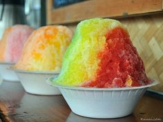 three bowls filled with different colored jello on top of a table