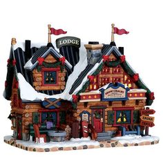 a christmas scene with a store front and snow on the roof, red ribbon around it