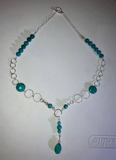 Make a statement without saying a word with this dainty and stylish turquoise beaded chain necklace. A teardrop bead is featured and surrounded by silver round connectors culminating in a toggle clasp.  Size is approximate. Teal Necklace, Beaded Chain Necklace, Necklace Turquoise, Teardrop Beads, Necklace Gemstone, Beaded Necklaces, Toggle Clasp, Turquoise Beads, Turquoise Jewelry