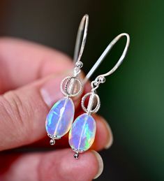 The Royal Earrings are so stunning you will feel the magic they hold inside of them. These are created with the most beautiful natural Ethiopian Opals with a blue and purple tone and rainbow flashes inside. These have gorgeous hoops and accent beads. The metal is all solid .925 sterling silver. These fabulous earrings dangle 2” down so they are perfect for wearing even when your hair is long and down. Royal Earrings, Purple Tone, Opal Earrings, Earrings Dangle, Ethiopian Opal, Solid 925 Sterling Silver, Blue And Purple, The Magic, Opal