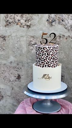 a white and black leopard print cake with the number 52 on it's top