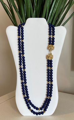 Kenneth Jay Lane's royal blue faux lapis beaded double strand necklace with double gold plated ram's heads encrusted with clear rhinestones and green rhinestone eyes. This was by designer Kenneth Jay Lane for Avon and in excellent condition. Please see pictures and video for description. Signed K.J.L. for Avon at clasp. Please visit my shop for more vintage jewelry: https://vintagetimejewelry.etsy.com/ Elegant Royal Blue Beaded Jewelry, Blue Beads Necklace, Business Jewelry, Ram Head, Rhinestone Eyes, Blue Beaded Necklace, Double Strand Necklace, Celebrity Design, Kenneth Jay Lane