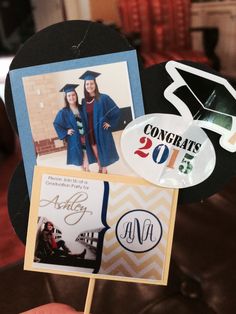 a hand holding up a graduation card with pictures on it and congratulationss in the background